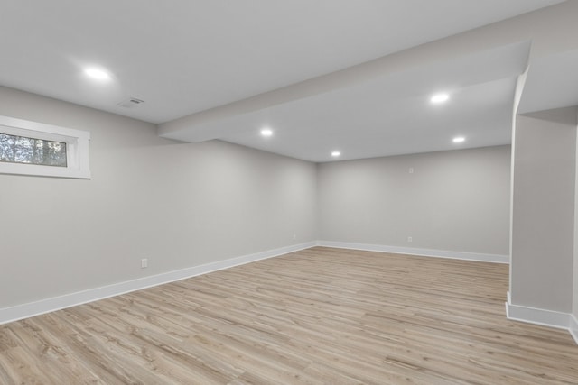 basement with recessed lighting, light wood-type flooring, visible vents, and baseboards