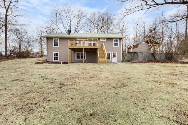 back of house featuring a yard, a chimney, stairway, metal roof, and a deck