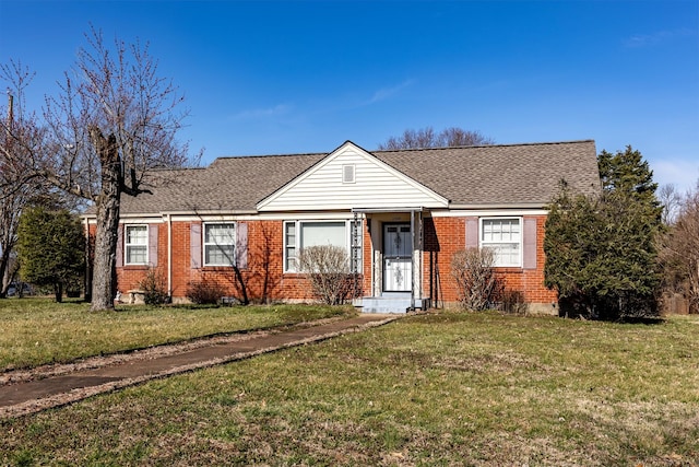 bungalow-style house with brick siding, a front lawn, and a shingled roof