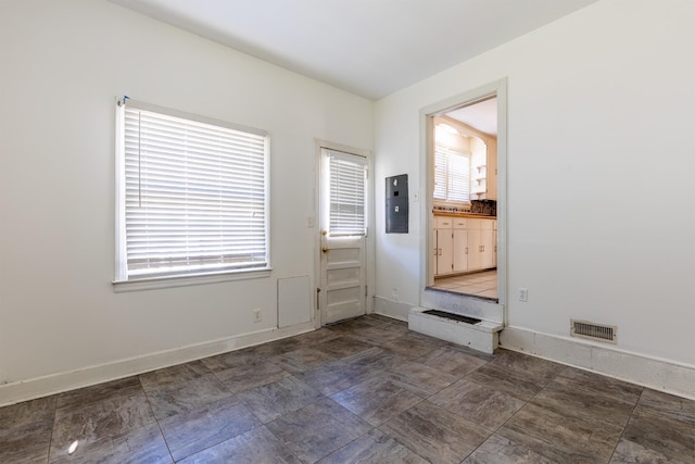 mudroom featuring visible vents, electric panel, and baseboards