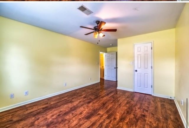 unfurnished bedroom with wood finished floors, visible vents, and baseboards