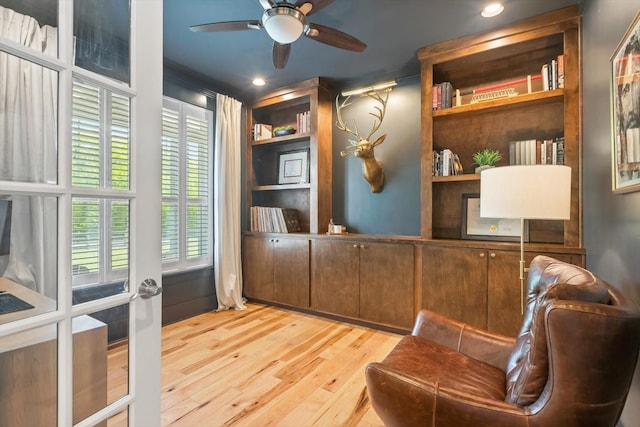 sitting room with built in features, french doors, recessed lighting, ceiling fan, and wood finished floors