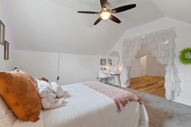 carpeted bedroom featuring vaulted ceiling, a ceiling fan, and baseboards