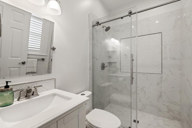 bathroom with tasteful backsplash, a stall shower, vanity, and toilet