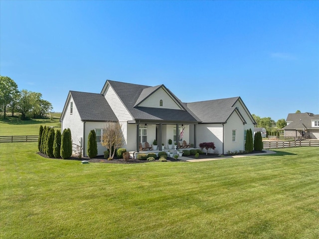 view of front of home featuring fence, a patio, and a front yard