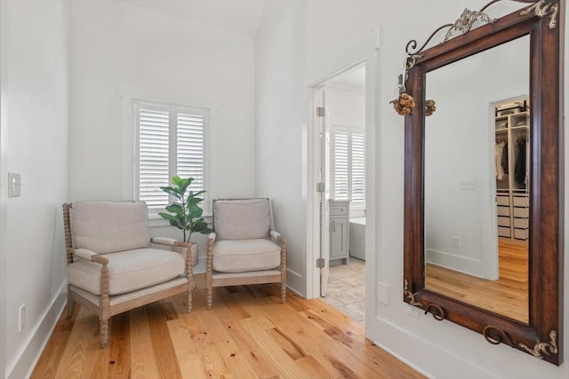 living area with baseboards and light wood-style floors