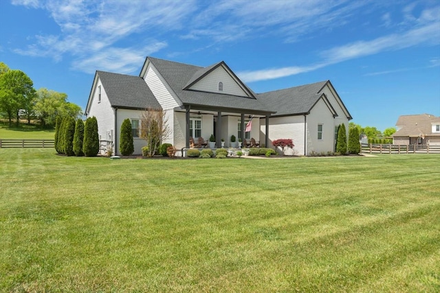 view of front of home featuring a front yard, a patio area, and fence