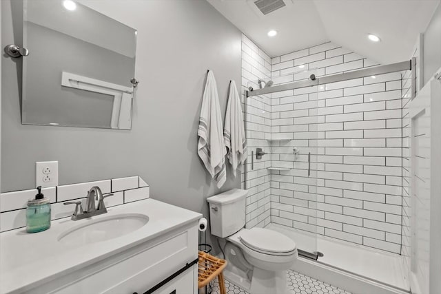 bathroom featuring toilet, recessed lighting, vanity, visible vents, and a stall shower