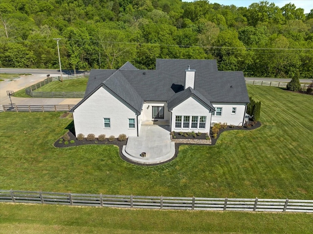 bird's eye view with a wooded view