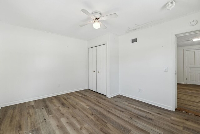 120 Wilkerson Ln, Portland, TN 37148 - unfurnished bedroom with baseboards, a closet, visible vents, and wood finished floors