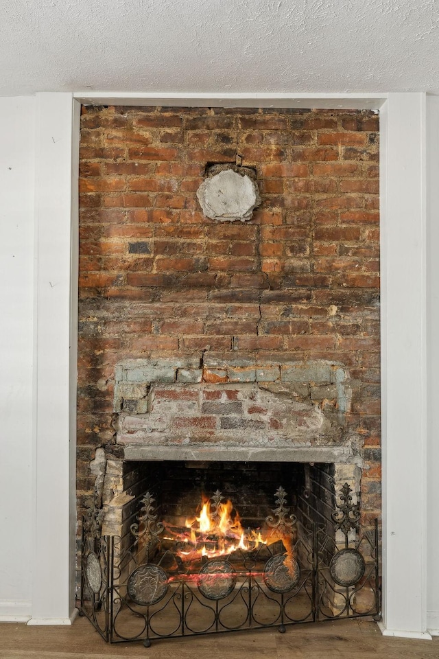 120 Wilkerson Ln, Portland, TN 37148 - room details with a brick fireplace, a textured ceiling, and wood finished floors