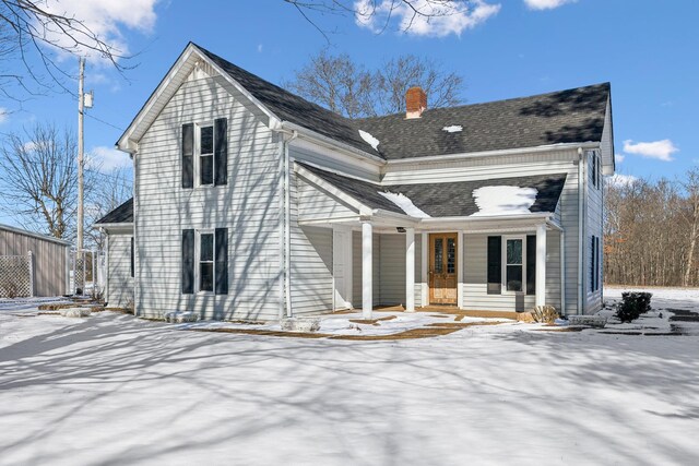 120 Wilkerson Ln, Portland, TN 37148 - snow covered back of property featuring a porch, roof with shingles, and a chimney