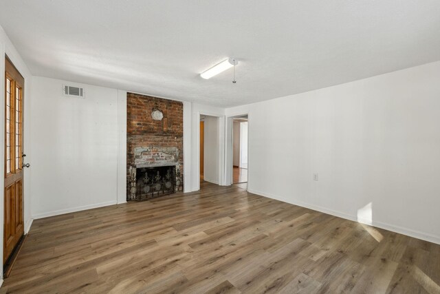 120 Wilkerson Ln, Portland, TN 37148 - unfurnished living room featuring visible vents, a fireplace, baseboards, and wood finished floors