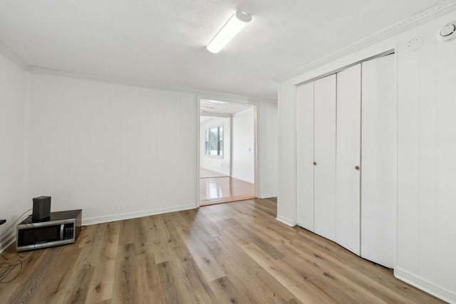120 Wilkerson Ln, Portland, TN 37148 - unfurnished bedroom with light wood-type flooring, baseboards, ornamental molding, and a closet