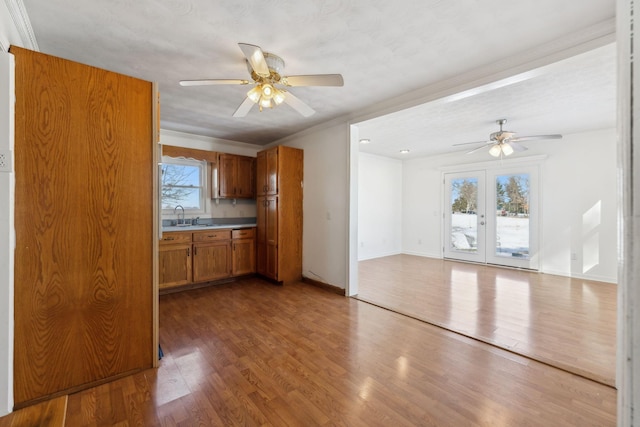 120 Wilkerson Ln, Portland, TN 37148 - kitchen featuring wood finished floors, a sink, baseboards, french doors, and brown cabinetry