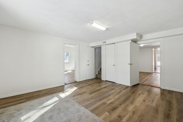 120 Wilkerson Ln, Portland, TN 37148 - unfurnished bedroom featuring baseboards, wood finished floors, visible vents, and multiple closets