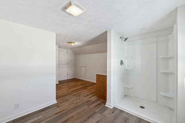 120 Wilkerson Ln, Portland, TN 37148 - full bathroom featuring visible vents, vaulted ceiling, a textured ceiling, wood finished floors, and walk in shower