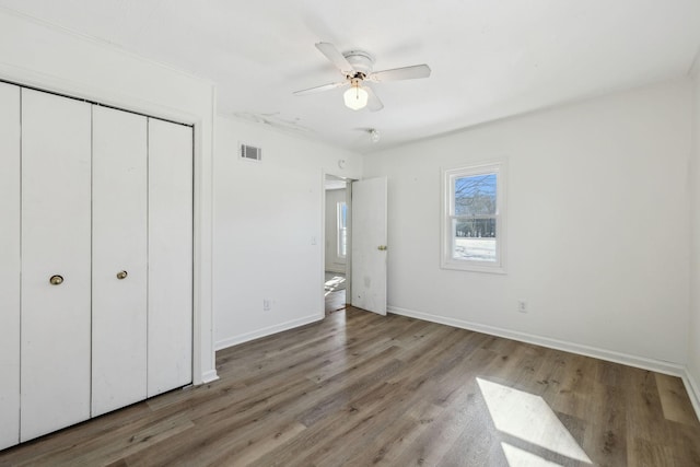 120 Wilkerson Ln, Portland, TN 37148 - unfurnished bedroom featuring a closet, visible vents, a ceiling fan, wood finished floors, and baseboards
