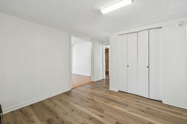120 Wilkerson Ln, Portland, TN 37148 - unfurnished bedroom featuring a closet, crown molding, baseboards, and wood finished floors