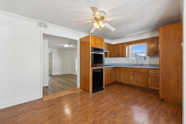 120 Wilkerson Ln, Portland, TN 37148 - kitchen featuring oven, a sink, wood finished floors, visible vents, and light countertops