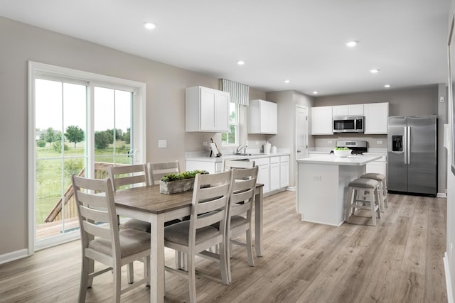 dining area with recessed lighting, light wood-style floors, and a wealth of natural light