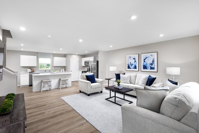 living area featuring recessed lighting and light wood-style flooring