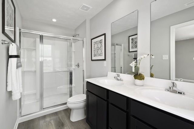 bathroom with a sink, visible vents, and a shower stall