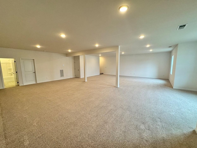 finished basement featuring recessed lighting, light colored carpet, visible vents, and baseboards