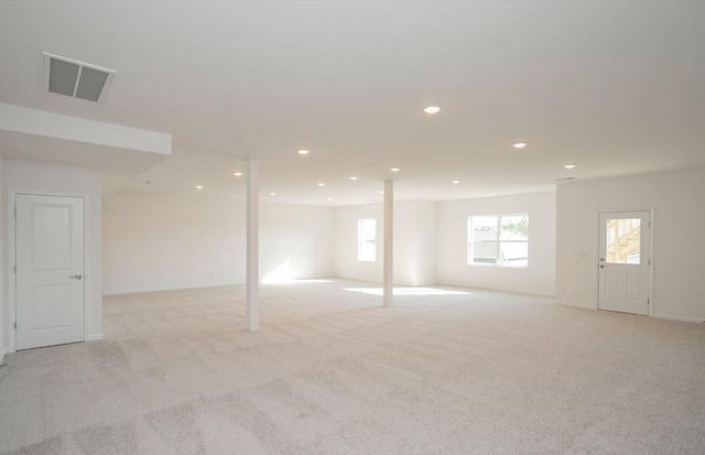 basement featuring recessed lighting, visible vents, light carpet, and baseboards