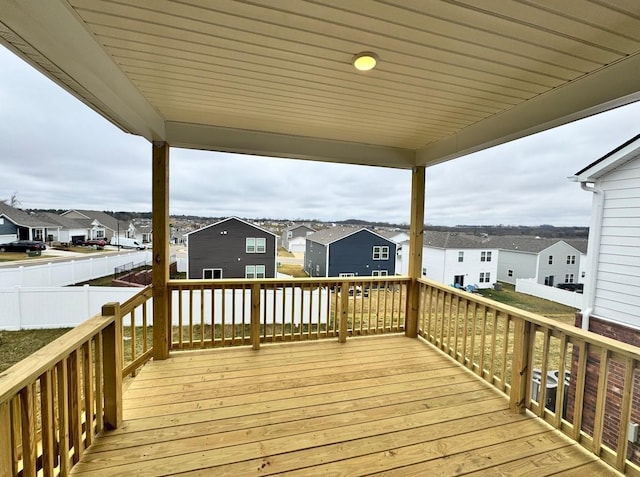 wooden deck featuring a residential view and fence