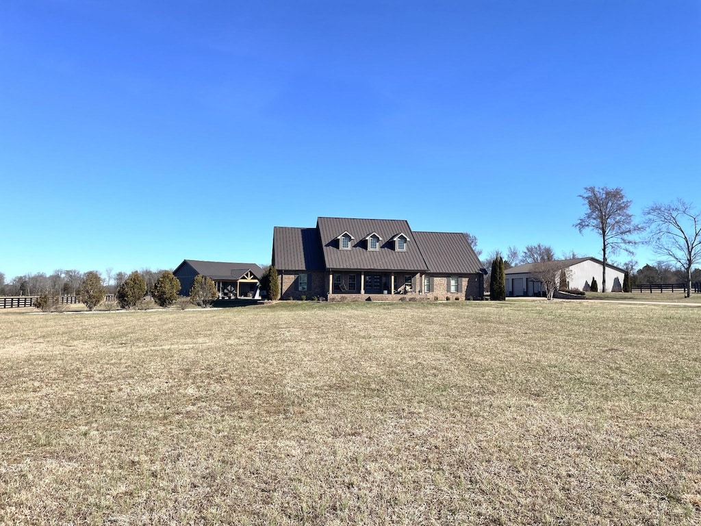 exterior space featuring a front lawn and metal roof