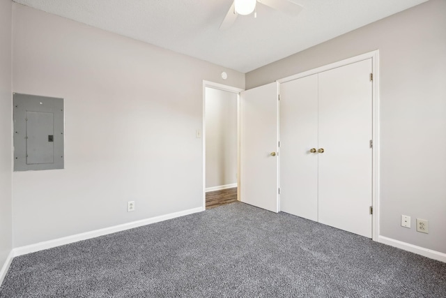 unfurnished bedroom with ceiling fan, carpet, electric panel, and baseboards