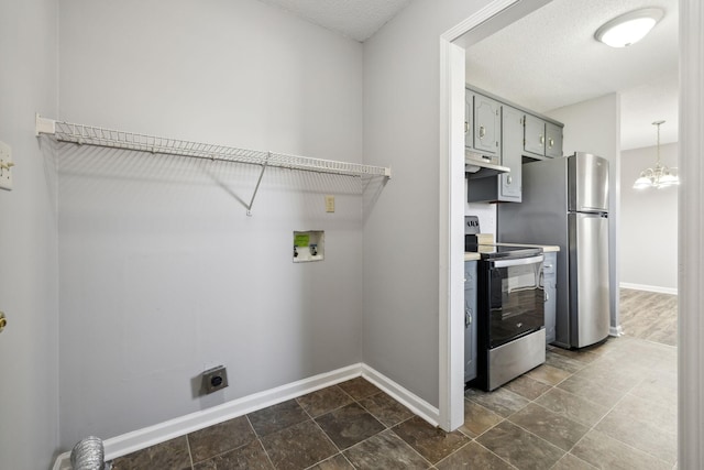 washroom with hookup for a washing machine, hookup for an electric dryer, baseboards, and an inviting chandelier