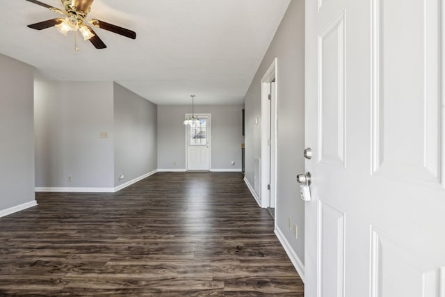 entrance foyer featuring dark wood-style flooring, baseboards, and ceiling fan with notable chandelier