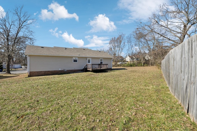 view of yard with fence and a wooden deck