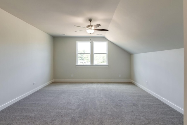 additional living space with ceiling fan, vaulted ceiling, carpet, and baseboards