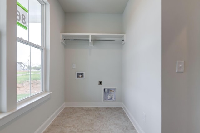 clothes washing area featuring laundry area, hookup for a washing machine, baseboards, and electric dryer hookup