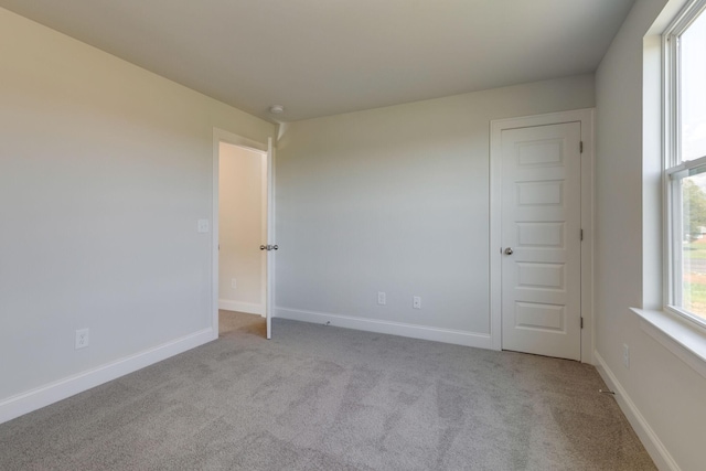 spare room with carpet flooring and baseboards