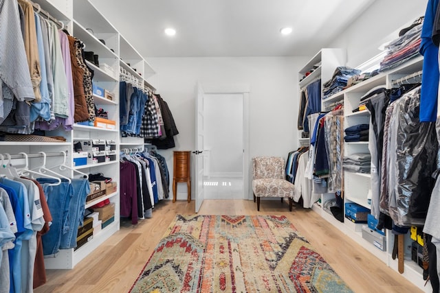 walk in closet with wood finished floors