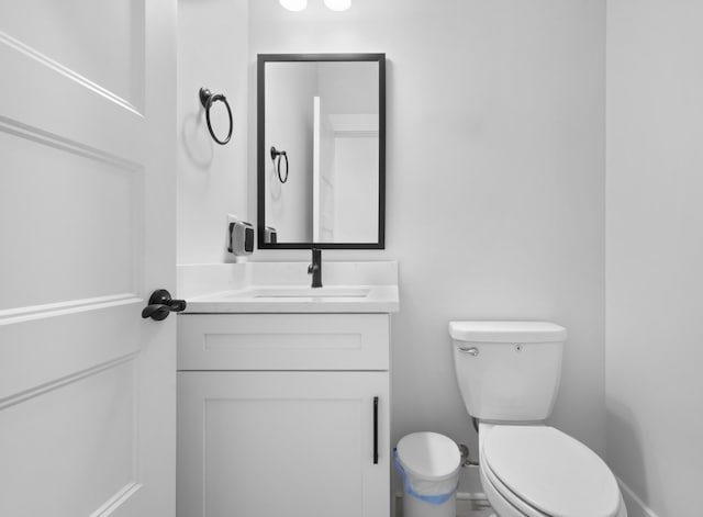 half bathroom with toilet and vanity