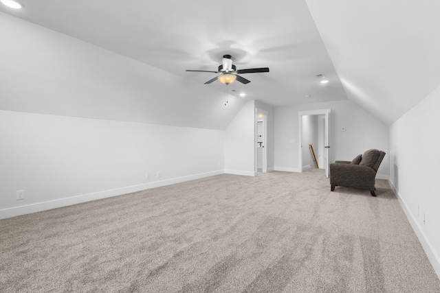 additional living space featuring lofted ceiling, light colored carpet, and baseboards