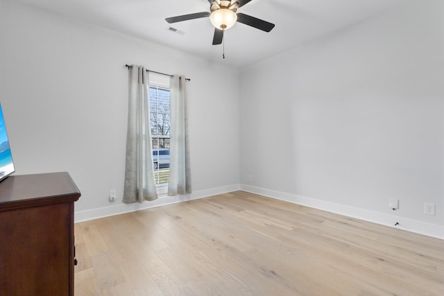 unfurnished room featuring visible vents, ceiling fan, light wood-style flooring, and baseboards