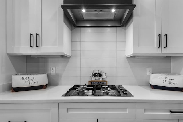 kitchen with light countertops, premium range hood, and white cabinetry