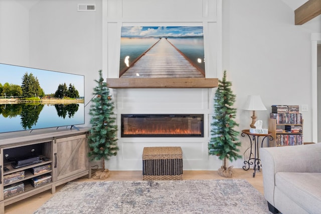 living room with a large fireplace and visible vents