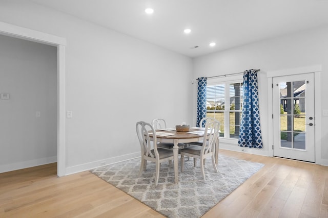 dining space featuring recessed lighting, baseboards, and wood finished floors