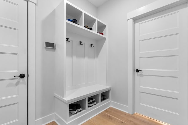 mudroom featuring light wood-type flooring and baseboards