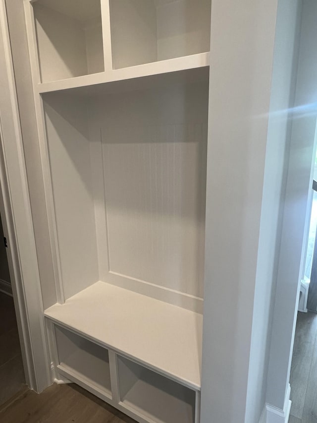 mudroom with dark wood finished floors