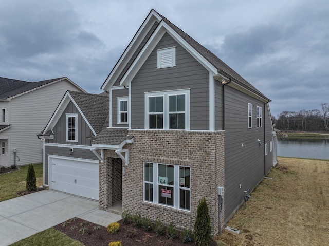 view of front of house featuring a garage, brick siding, concrete driveway, roof with shingles, and board and batten siding