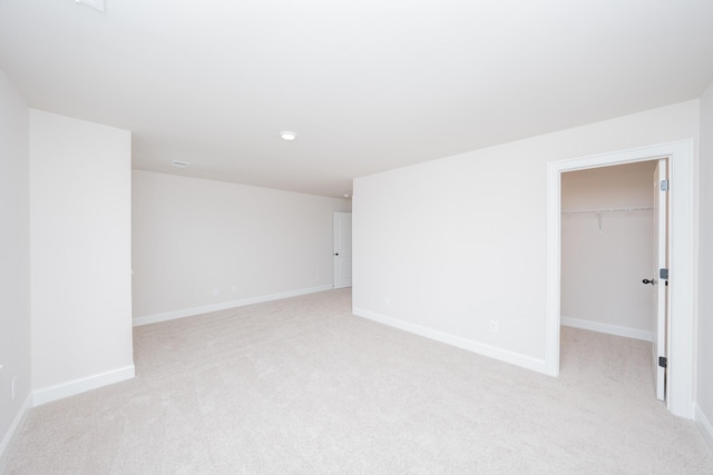 empty room with light colored carpet and baseboards