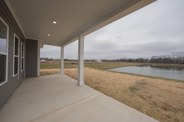 view of patio with a water view